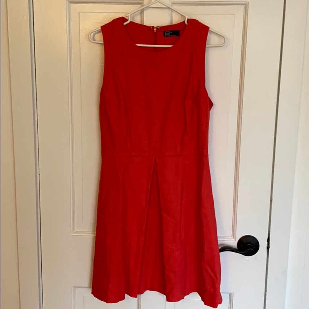 Coral colored fit and flare sleeve less dress.